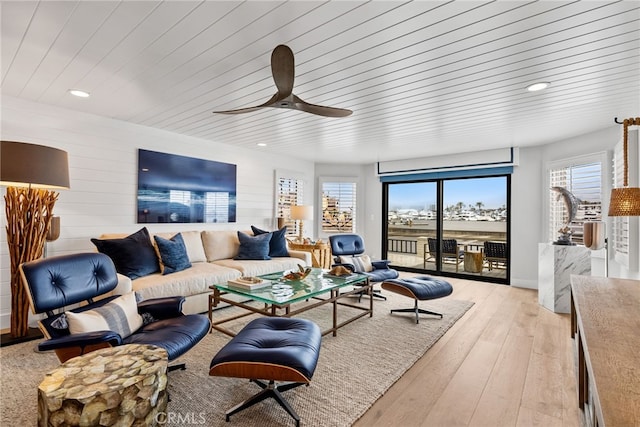 living room featuring a ceiling fan, wood ceiling, recessed lighting, and light wood-style floors