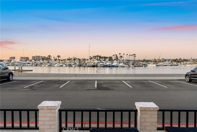 uncovered parking lot with a water view