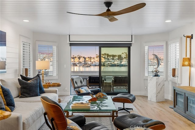 living room featuring a ceiling fan, plenty of natural light, light wood-style floors, and recessed lighting