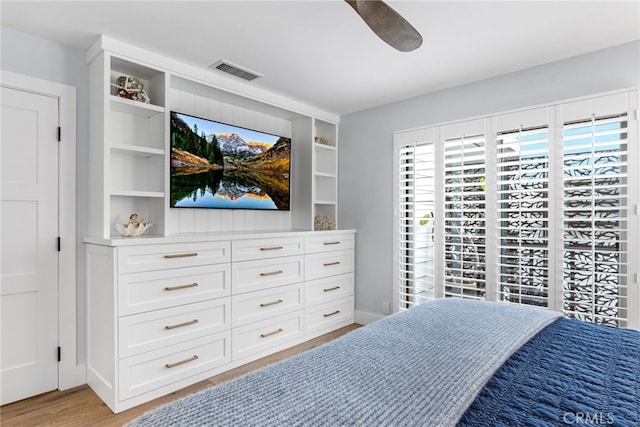 bedroom with a ceiling fan, visible vents, light wood finished floors, and baseboards