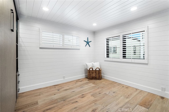 empty room featuring wood ceiling, recessed lighting, wood finished floors, and baseboards