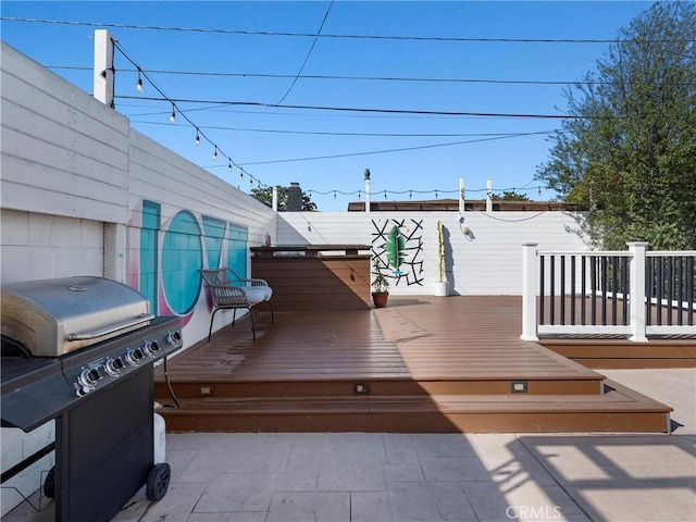 wooden terrace featuring area for grilling