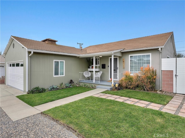 ranch-style house with a front yard, fence, driveway, covered porch, and a garage