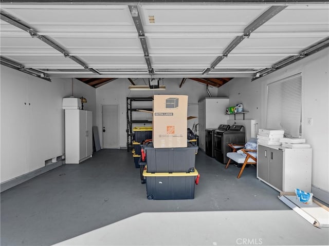 garage featuring washing machine and dryer