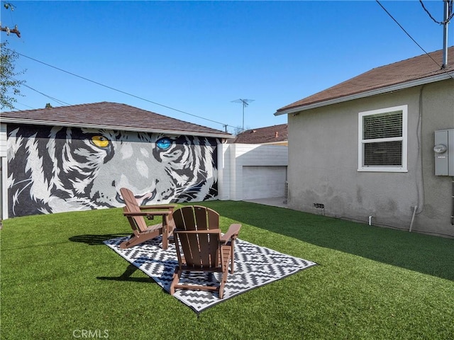 view of yard featuring an outbuilding and a patio