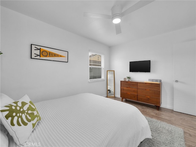 bedroom featuring baseboards, ceiling fan, and wood finished floors