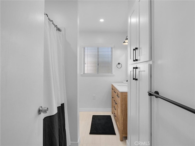 full bath featuring recessed lighting, curtained shower, baseboards, and vanity