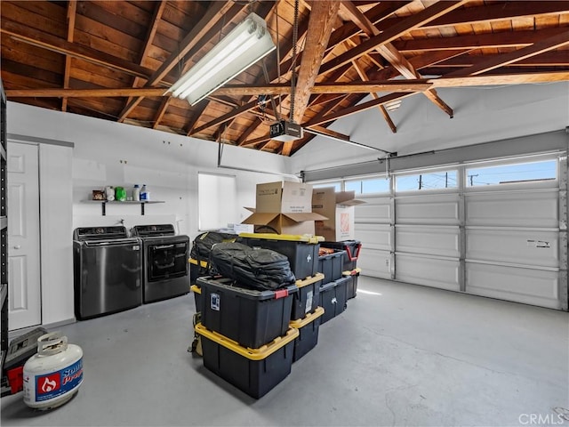 garage featuring washing machine and dryer and a garage door opener