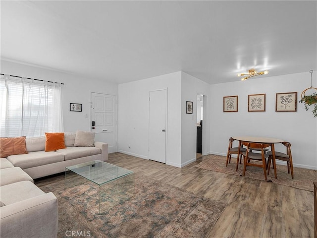 living room featuring baseboards and wood finished floors