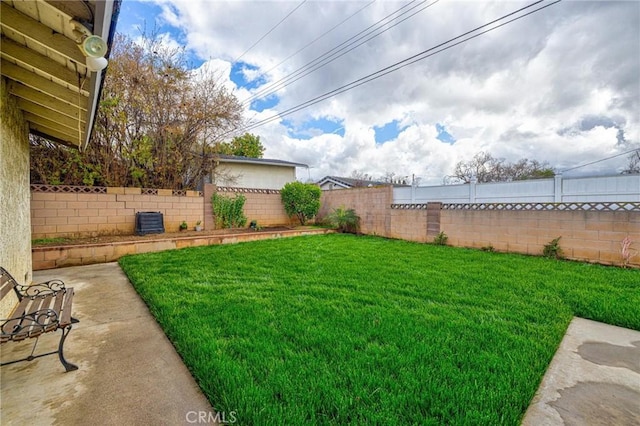 view of yard with a patio, cooling unit, and a fenced backyard