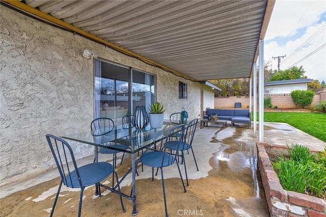 view of patio with outdoor lounge area, outdoor dining space, and fence