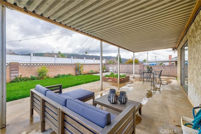 view of patio / terrace featuring an outdoor living space and a fenced backyard