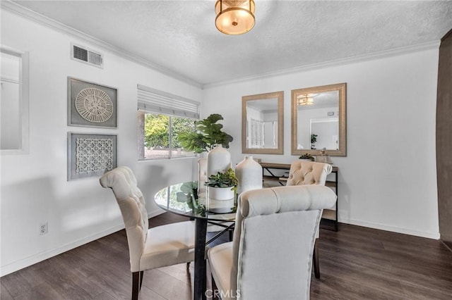 dining room with visible vents, a textured ceiling, wood finished floors, and crown molding