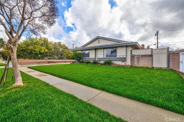 view of front of house with a front lawn and fence