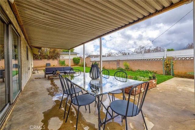 view of patio / terrace featuring outdoor dining space, outdoor lounge area, and a fenced backyard