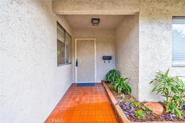 property entrance with stucco siding