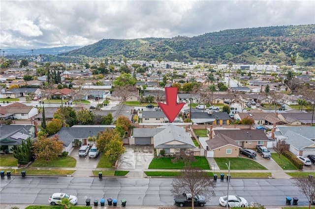 birds eye view of property featuring a mountain view and a residential view