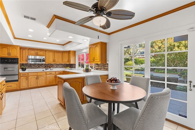 kitchen featuring a warming drawer, stainless steel appliances, plenty of natural light, and visible vents