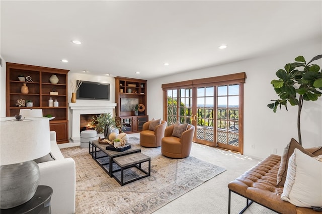 living area featuring recessed lighting, a premium fireplace, and light colored carpet