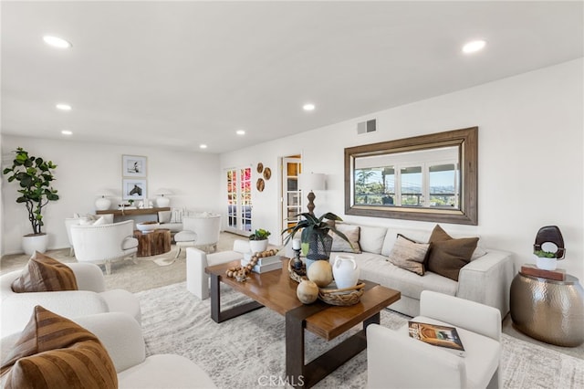 living room with recessed lighting, visible vents, and carpet