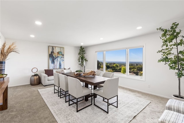 dining room featuring recessed lighting, light colored carpet, and baseboards