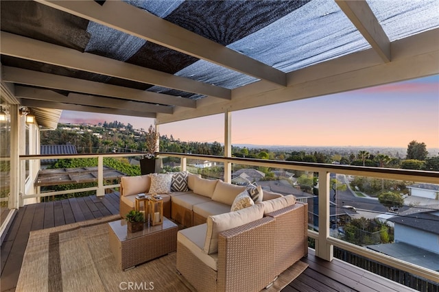 deck at dusk featuring an outdoor living space