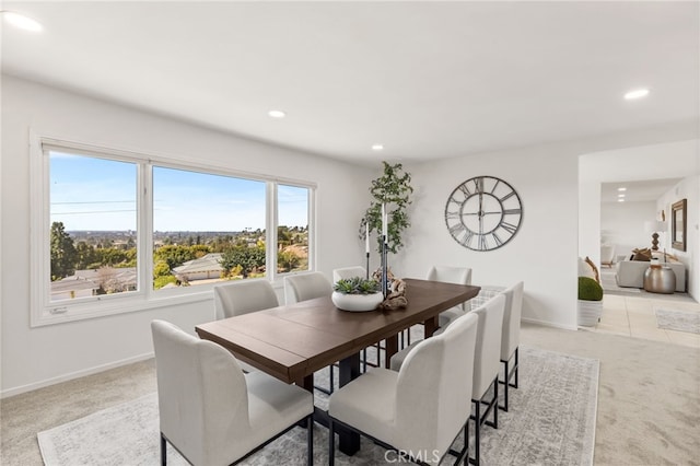 dining room with recessed lighting, light colored carpet, and baseboards