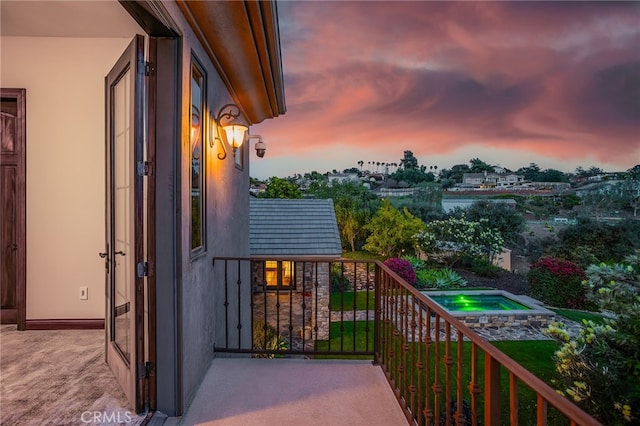 view of balcony at dusk