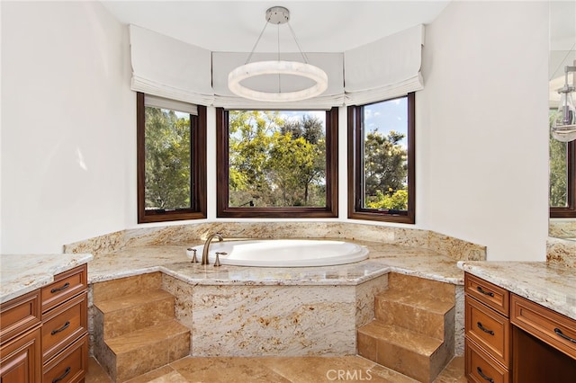 bathroom featuring a garden tub and a healthy amount of sunlight