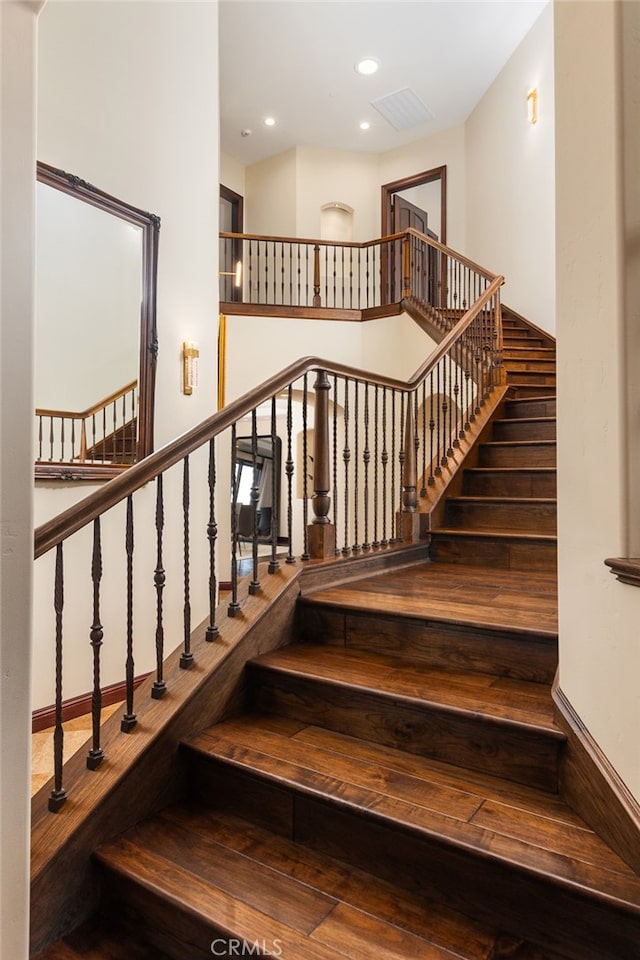 staircase featuring recessed lighting