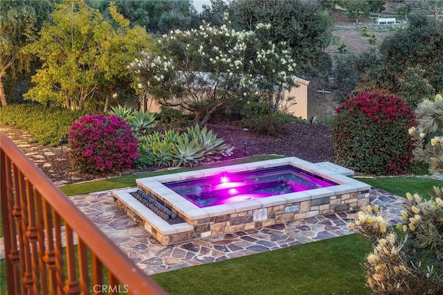 view of pool with an in ground hot tub