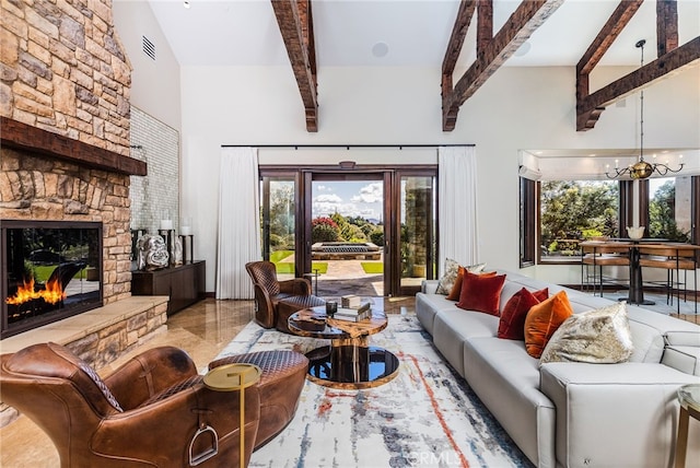 living area with a wealth of natural light, visible vents, an inviting chandelier, and a fireplace