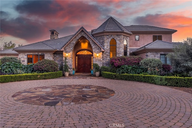 3221 Integrity Way, Fallbrook, CA 92028 - french country inspired facade featuring stone siding, curved driveway, and stucco siding