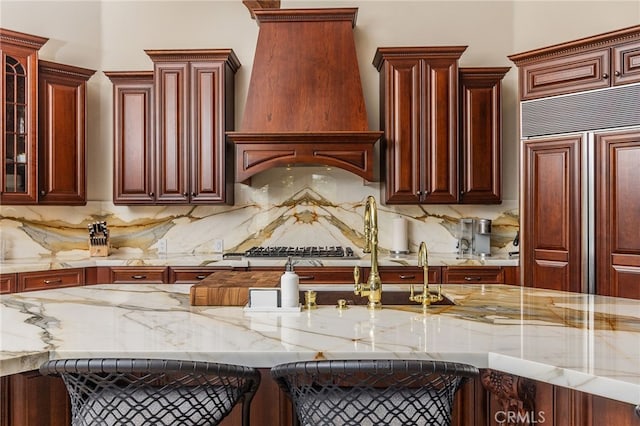 3221 Integrity Way, Fallbrook, CA 92028 - kitchen with paneled fridge, dark brown cabinets, custom range hood, and backsplash