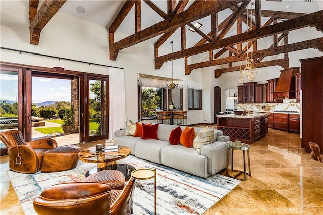 living room with beam ceiling, arched walkways, a chandelier, and high vaulted ceiling