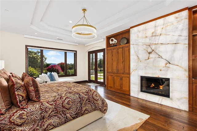3221 Integrity Way, Fallbrook, CA 92028 - bedroom with a tray ceiling, access to exterior, dark wood-style flooring, a fireplace, and recessed lighting