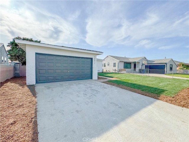 ranch-style house with a garage, an outdoor structure, a front yard, and fence