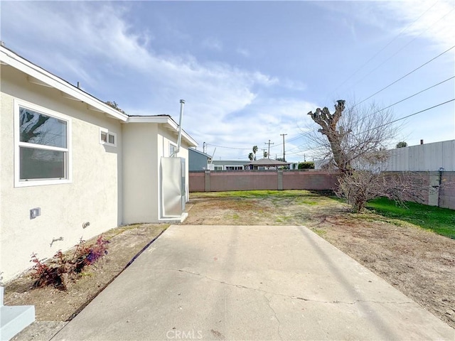 view of yard featuring a patio and fence