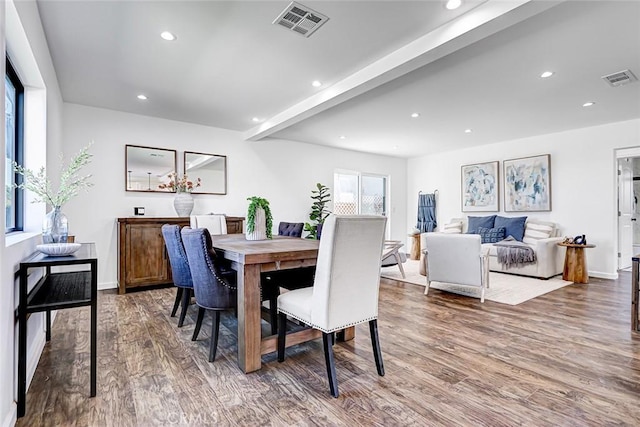 dining space featuring beamed ceiling, recessed lighting, wood finished floors, and visible vents