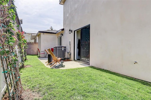 view of yard featuring a patio, central AC, and fence