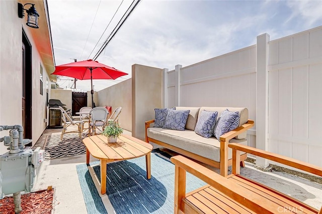 view of patio / terrace with an outdoor living space and fence