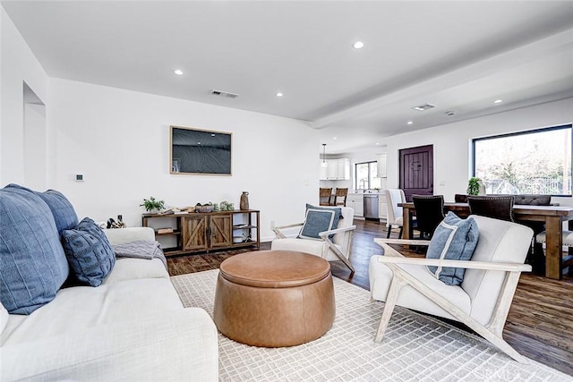 living area featuring recessed lighting, visible vents, and wood finished floors