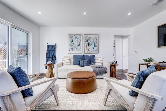 living area with visible vents, recessed lighting, baseboards, and wood finished floors