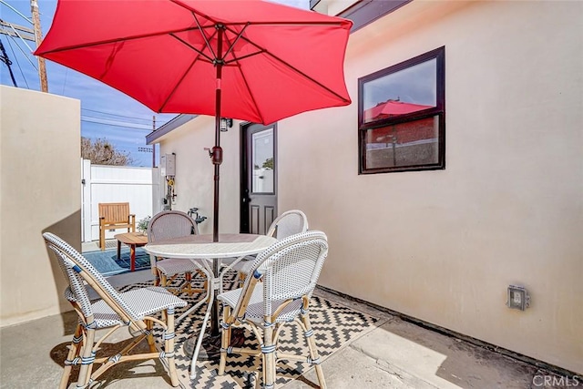 view of patio / terrace featuring outdoor dining area and fence