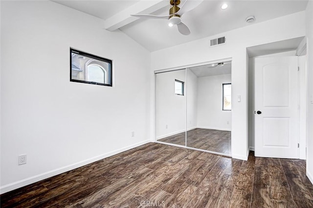 unfurnished bedroom featuring visible vents, baseboards, a closet, and wood finished floors