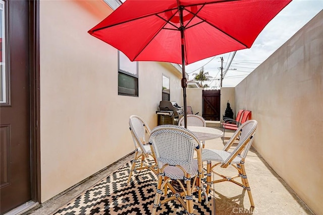 view of patio / terrace with outdoor dining space and fence