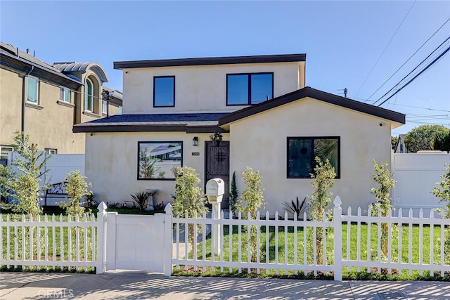 view of front of house featuring a fenced front yard and stucco siding