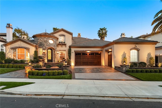 10 Corte Vizcaya, San Clemente, CA 92673 - view of front of property with stucco siding, a garage, driveway, a chimney, and stone siding