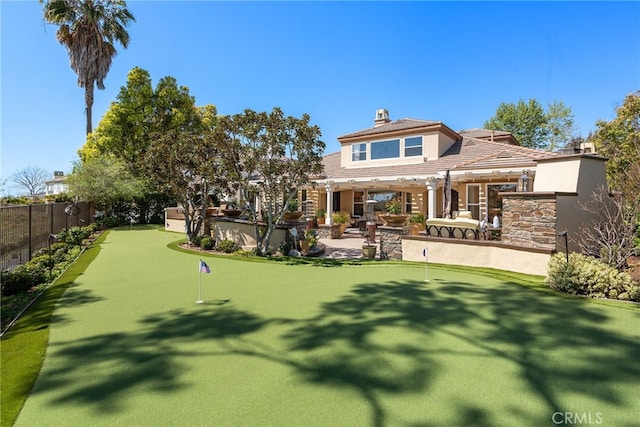 10 Corte Vizcaya, San Clemente, CA 92673 - rear view of property with a putting area, a patio, a chimney, and stone siding