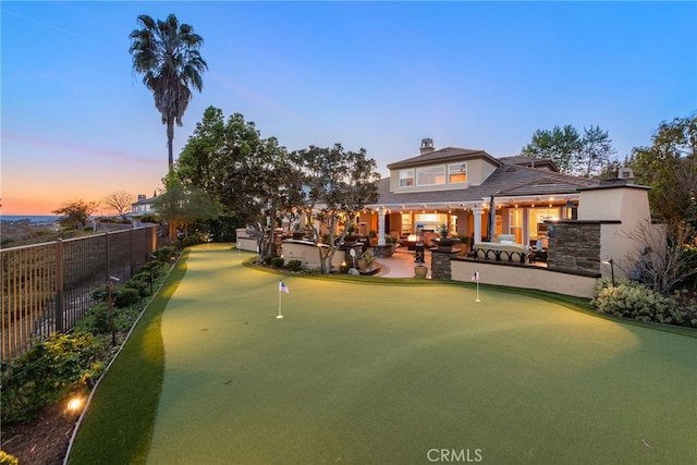 10 Corte Vizcaya, San Clemente, CA 92673 - back of house featuring a putting area, a patio area, and a chimney